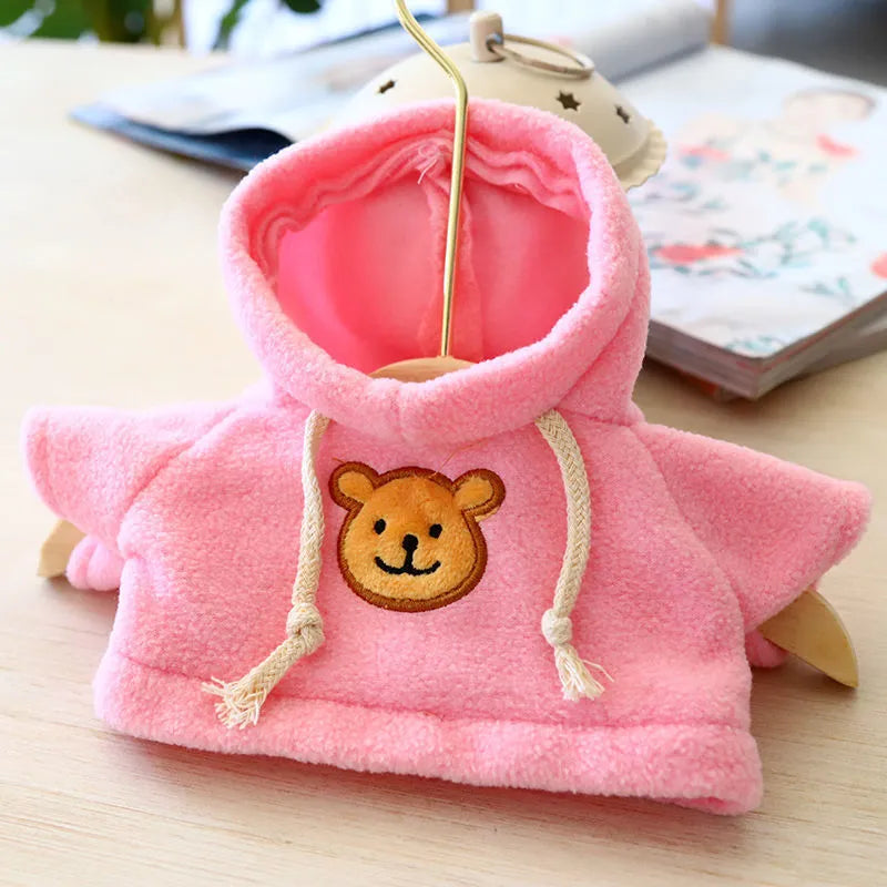 A selection of dog sweaters and hoodies in blue, pink, red, yellow, brown, and grey bear designs, shown in medium and large sizes.