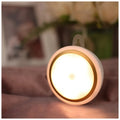 Smart body motion sensor LED night light with 80mm diameter showing warm and white light options