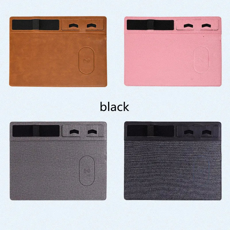 Large pink wireless charging mouse pad with integrated mobile phone holder on a desk.