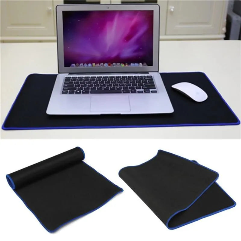 Oversized rubber mouse pad 30x60cm with stitched edges, black colour, on a desk with keyboard and mouse