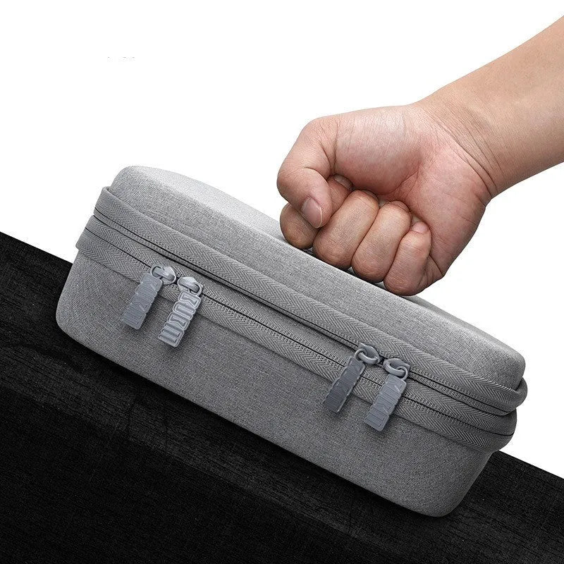 Black and grey EVA digital storage bag for headphones and cables, showing hand bag shape.