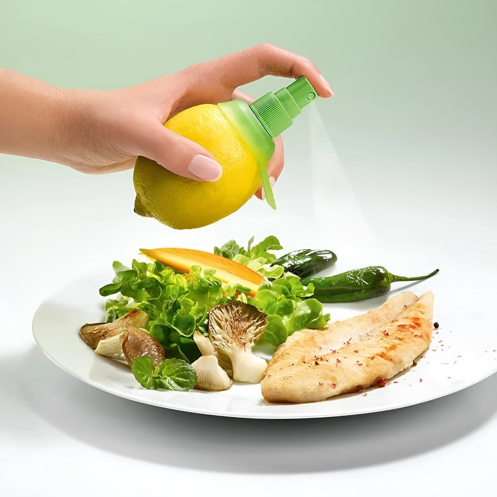 Green plastic lemon sprayer juice dispenser with screw-in nozzle on a white background