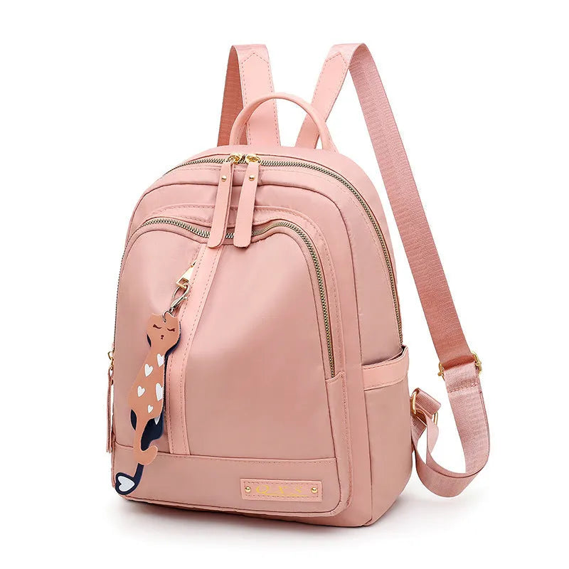 Women's black nylon casual backpack with double shoulder straps showing internal compartments and waterproof features
