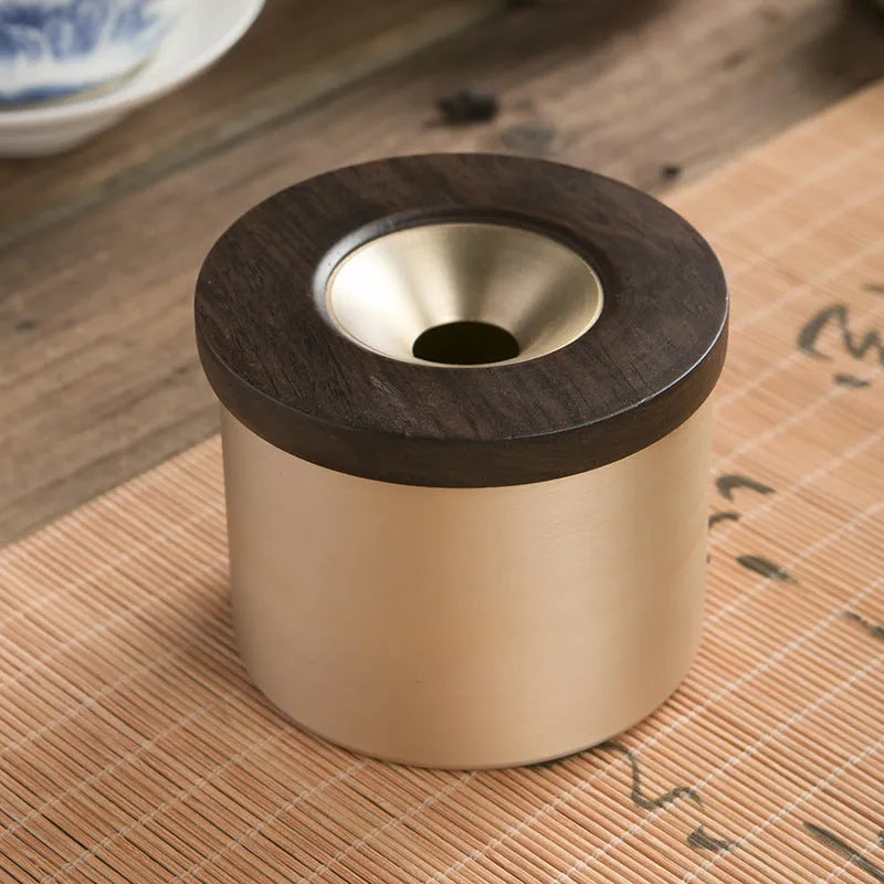 Brass retro ashtray with wooden lid in copper finish on living room table