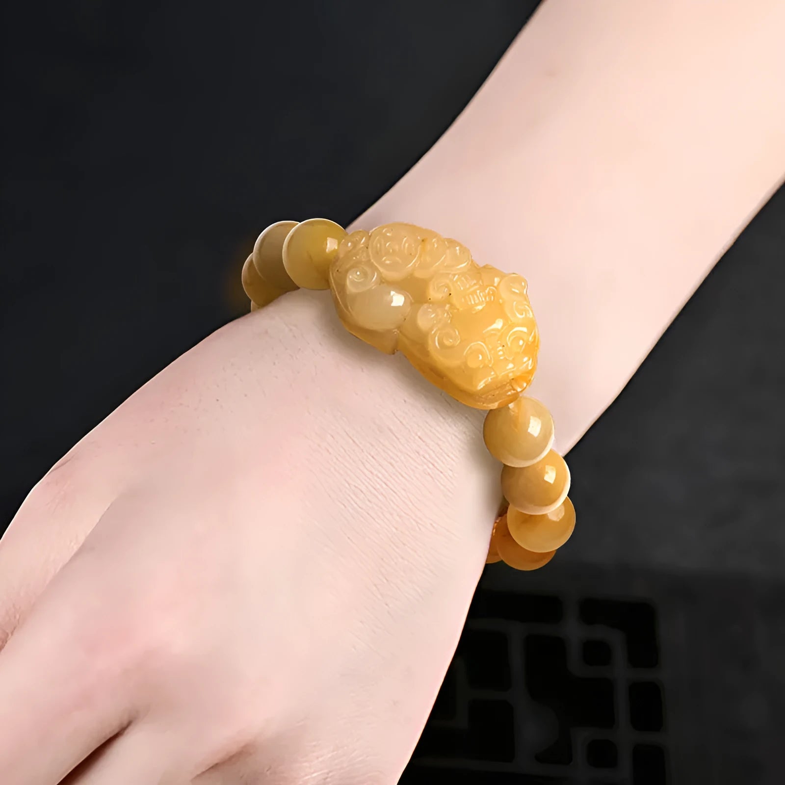 Jade money bracelet showing carved Jinsi Jade stone with beads in Golden Thread Jade colour