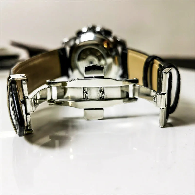 Men's automatic mechanical watch with silver case and black dial showing 12mm thickness