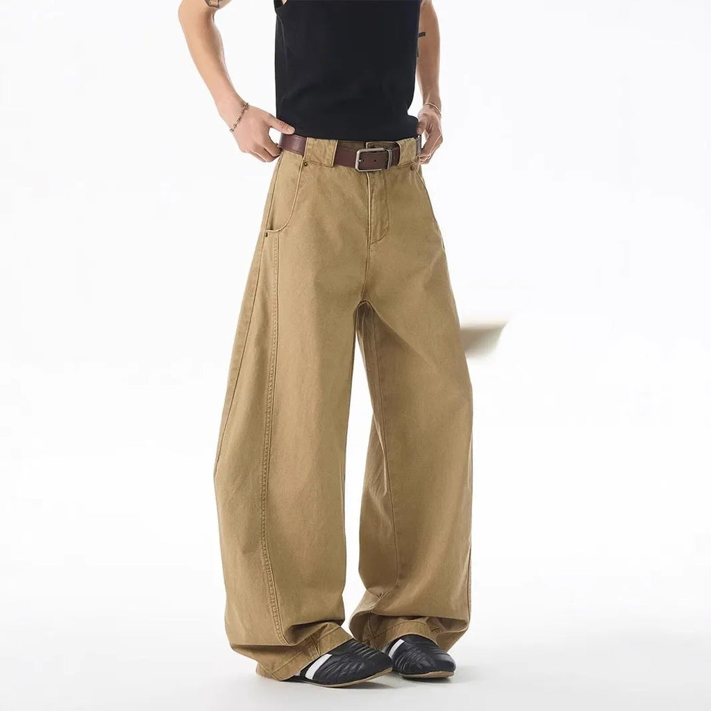 Men's brown loose-fit straight leg denim jeans on a plain background