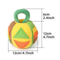 Green polyester squeaky plush ball dog toy with treat pockets on grass
