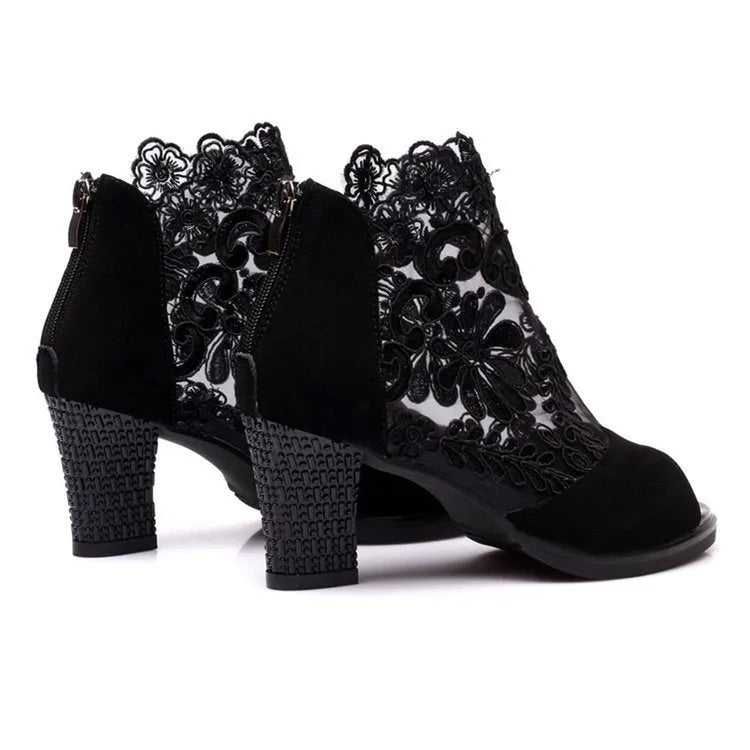 Black lace gladiator sandals for women with a square high heel and peep toe, showing zip closure.