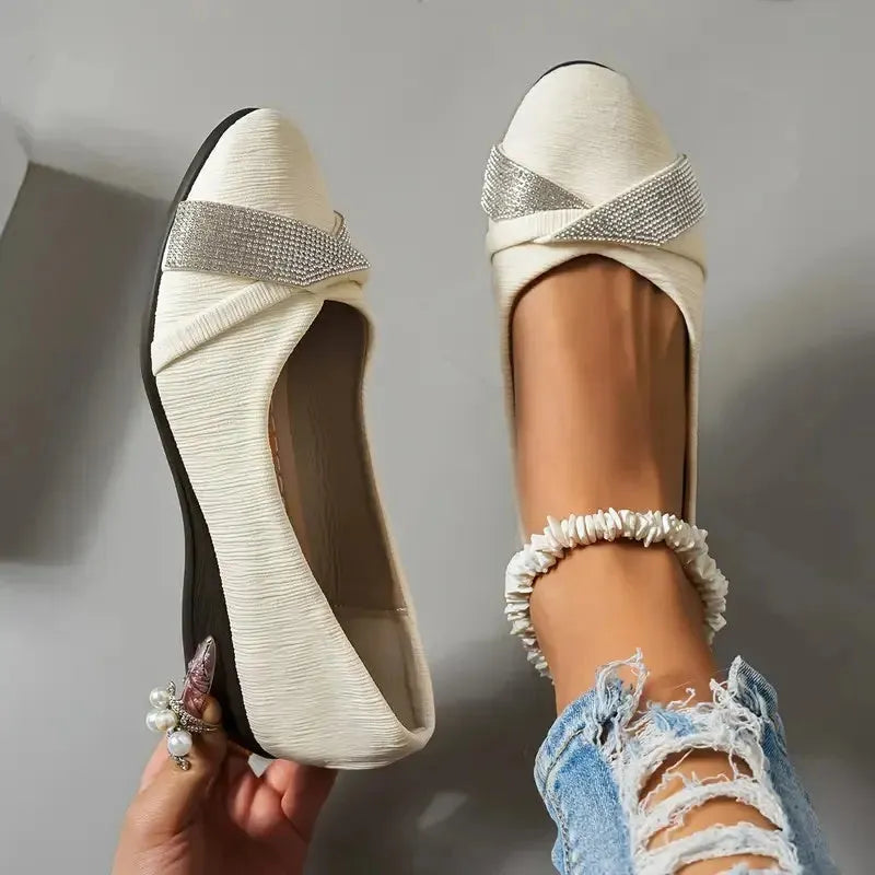 Black women's low-cut slip-on casual shoes with rhinestone decoration and a chunky short heel.