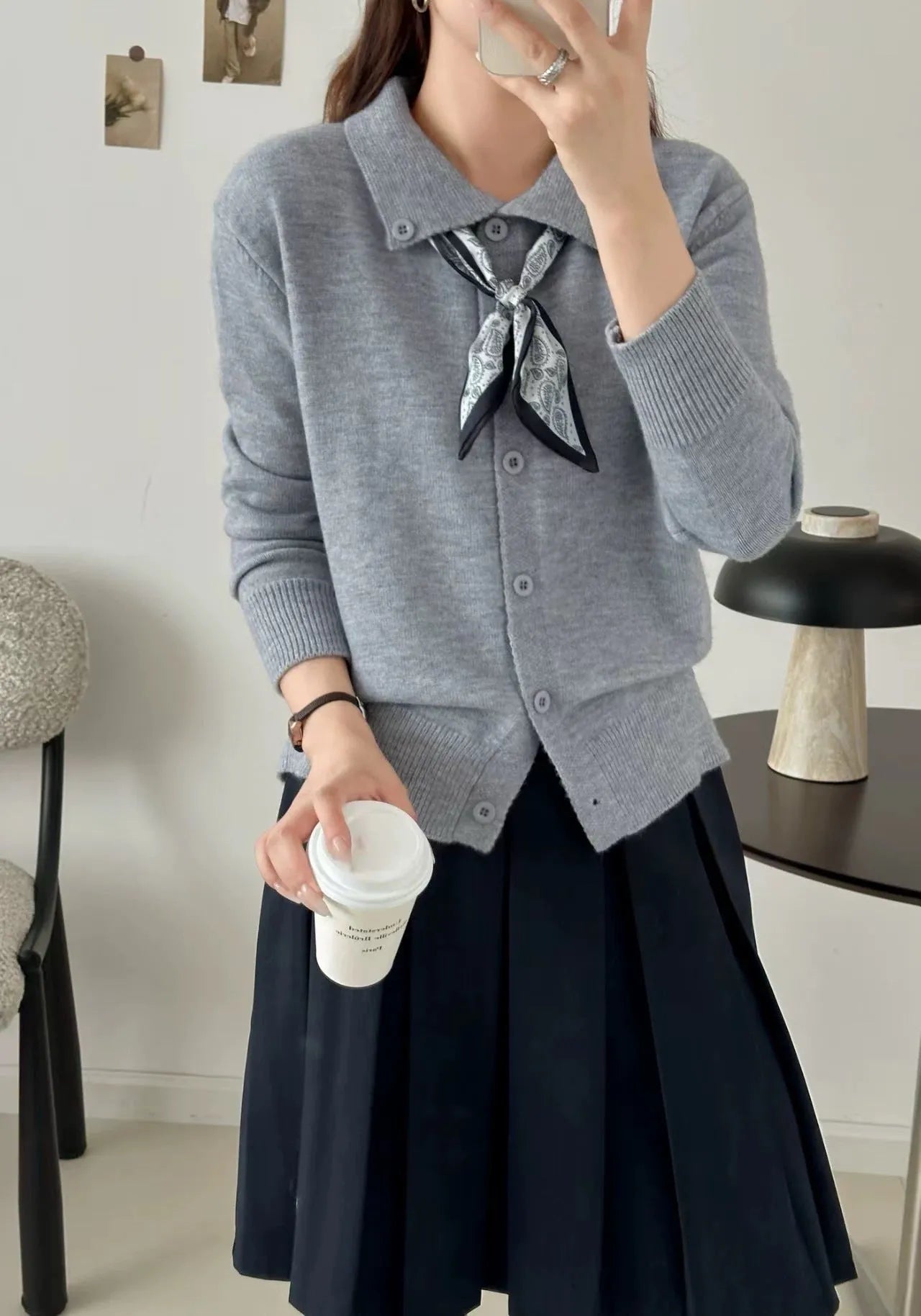 Beige lapel scarf cardigan sweater with long sleeves and splicing details on a model.