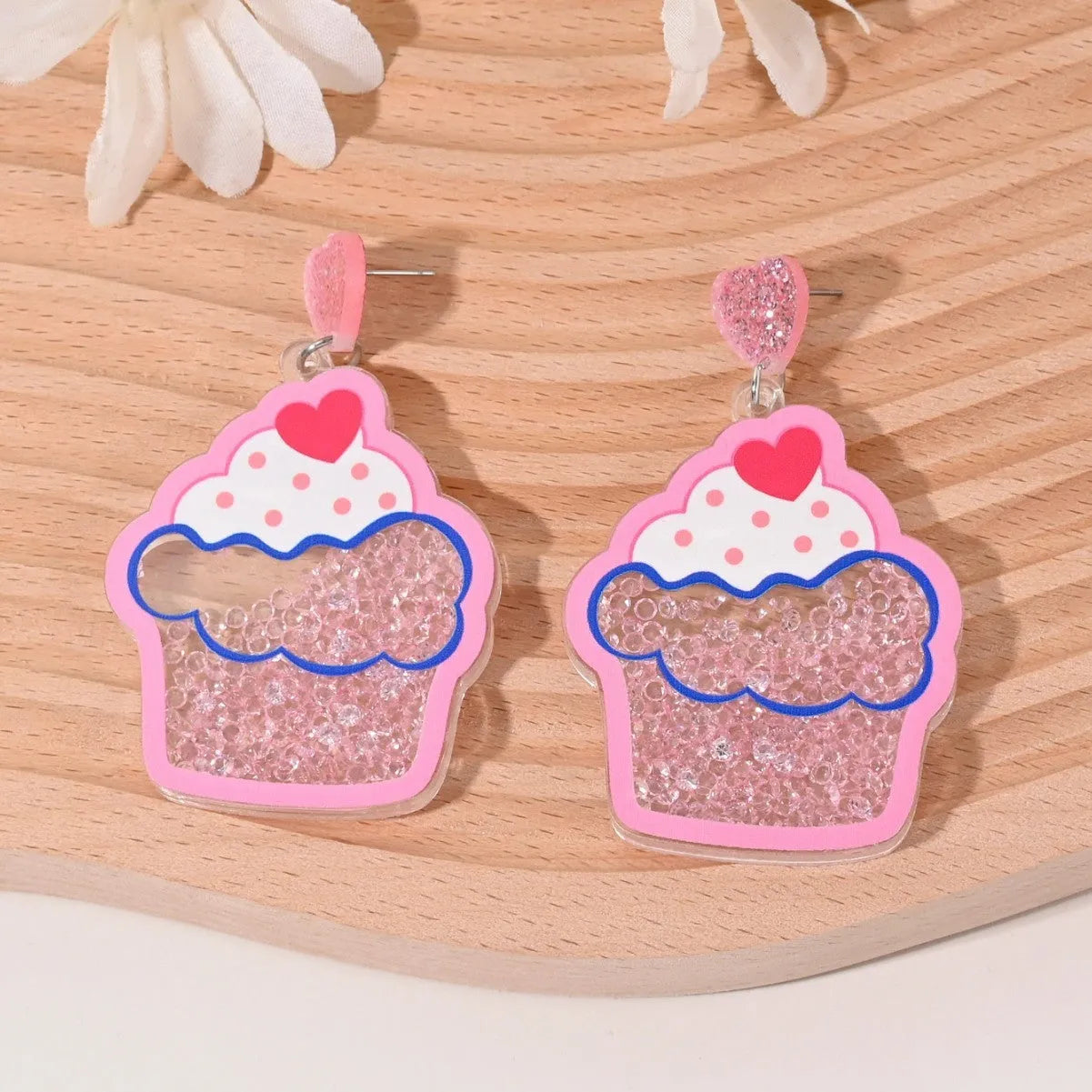 Colourful acrylic novelty earrings shaped like fruits and desserts including cherry, strawberry, and ice cream.