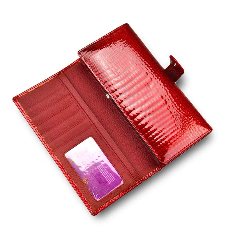 Women's red patent leather coin purse with crocodile pattern texture.