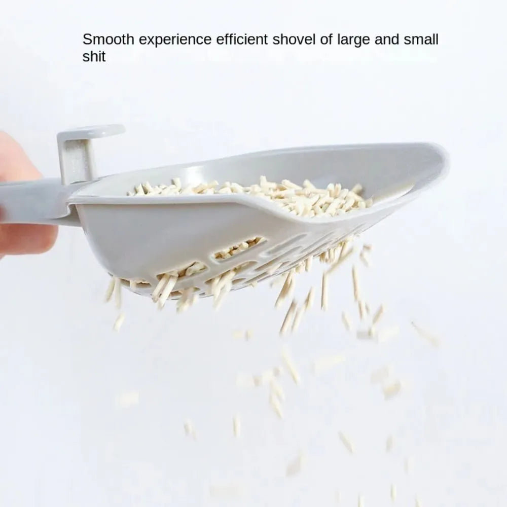 Grey plastic cat litter scoop with attached storage base, showing 4-hole sifter design.