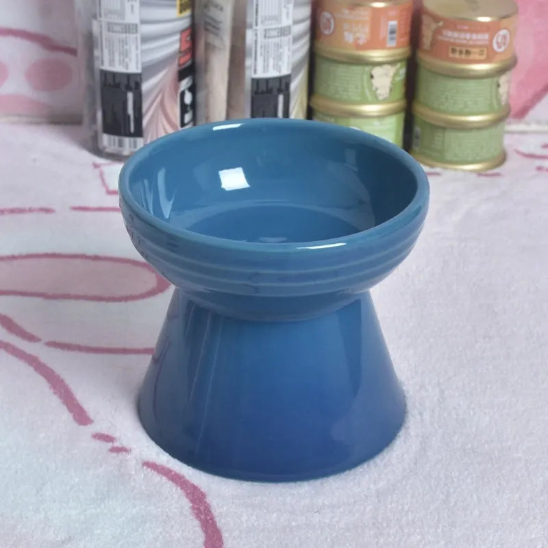 A white ceramic pet bowl with a high foot and raised neck protector to prevent tipping.