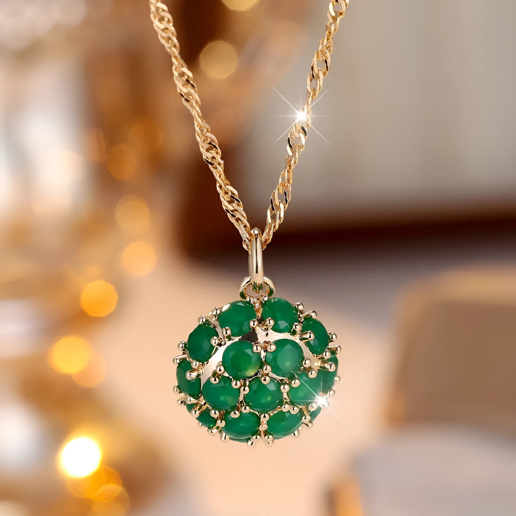Round emerald pendant with full diamond setting on champagne gold chain necklace