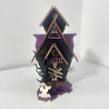 Wooden DIY Halloween haunted house table decoration with glow-in-the-dark details, shown unpainted.