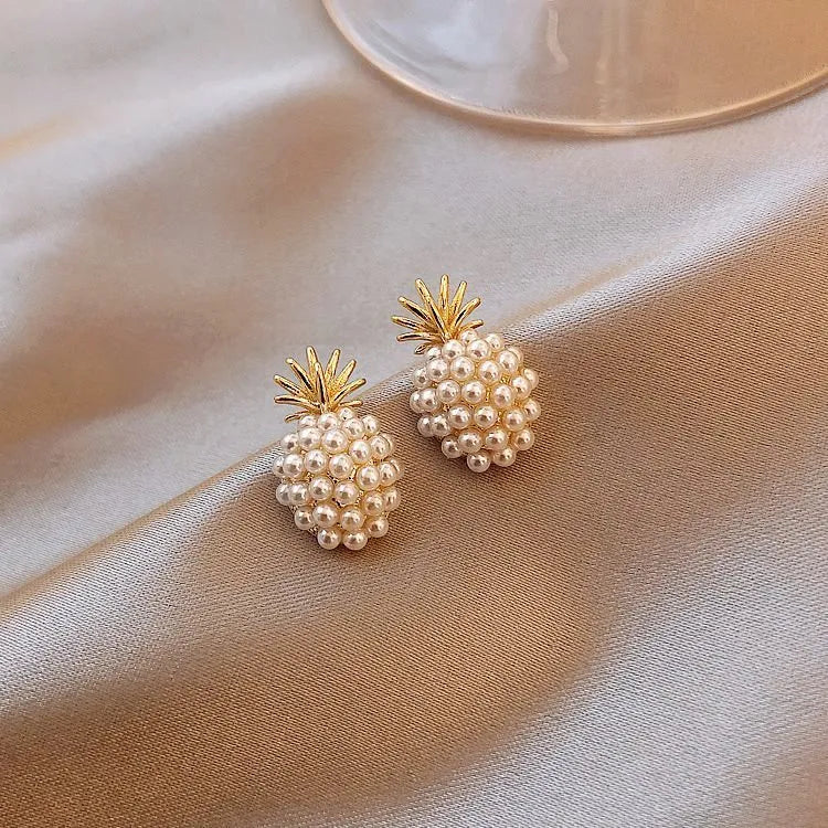 Gold Korean-style alloy earrings with pineapple starfish design and pearl-coloured gem inlays.