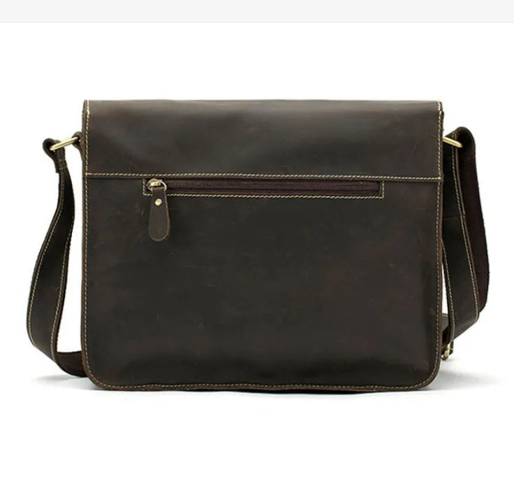 Brown leather vintage messenger bag with crossbody strap open showing laptop compartment