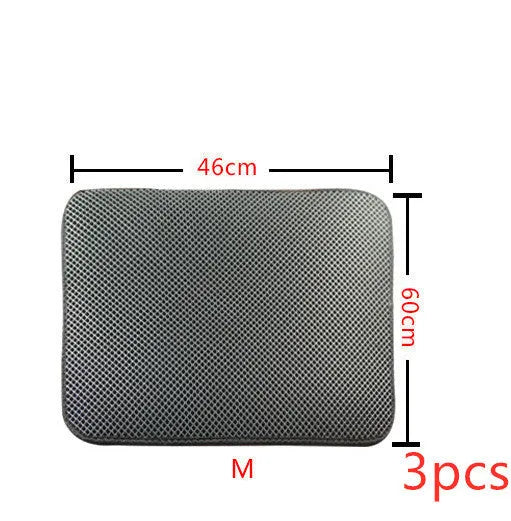Double layer EVA cat litter mat in black with textured surface, placed under a litter box to trap debris