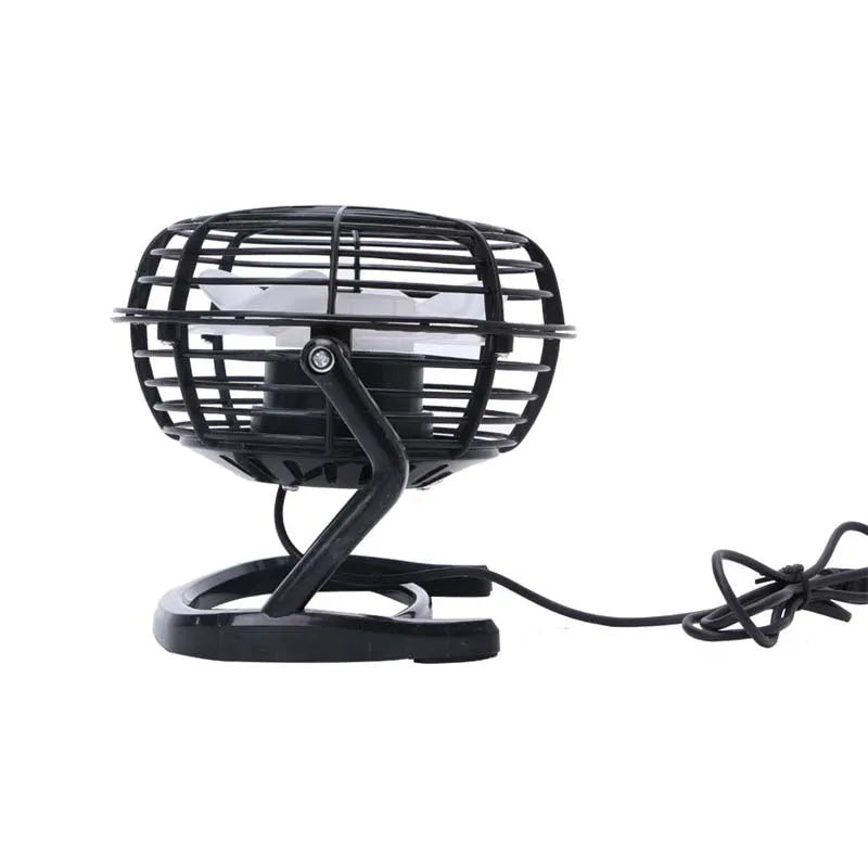 Compact black mini USB desk fan with adjustable tilt, placed next to a laptop.