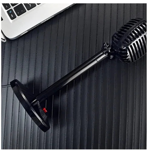 Black USB condenser microphone on an adjustable stand with a foam pop filter and weighted base.