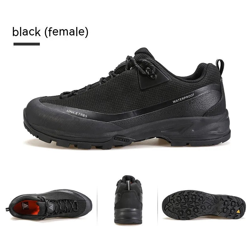 Men's low-top hiking boot in black with front lace-up, rubber outsole, and leather mesh upper.