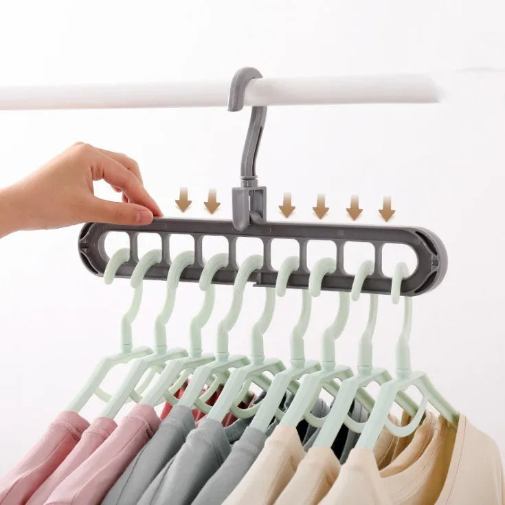 Plastic clothes hanger with rotating hook in assorted colours on white background