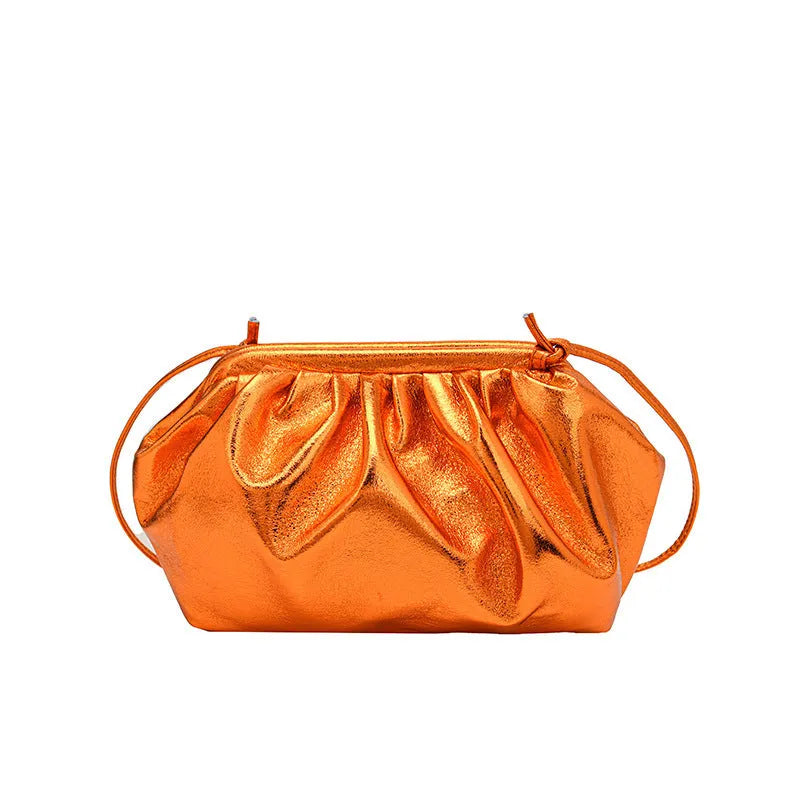Shell-shaped shoulder crossbody bag with hair clip closure in rose red colour showing interior organisation compartments