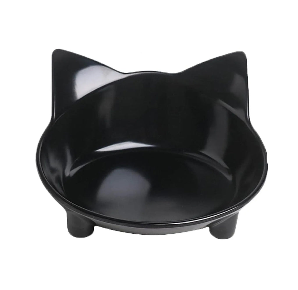 Set of four shallow black and white cat bowls with non-slip bases on a kitchen counter
