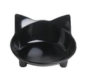 Set of four shallow black and white cat bowls with non-slip bases on a kitchen counter