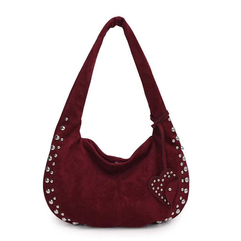 A soft plush underarm tote handbag in a retro style, shown in a colour option.