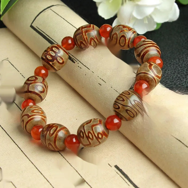 Agate Tibetan dzi bead bracelet with three-eye design and polished finish
