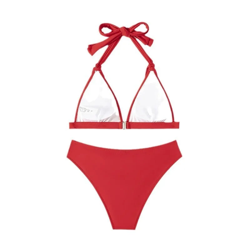 Red women's lace-up halterneck bikini set with split shorts for swimming
