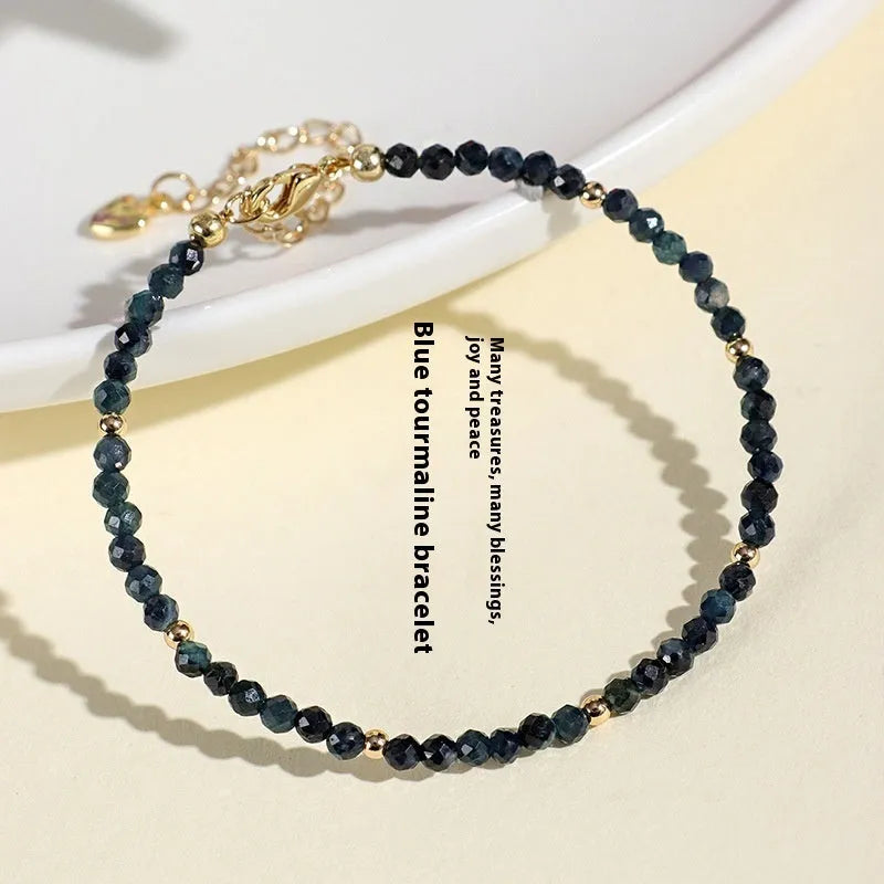 Women's blue tourmaline bracelet with 3mm beads and gold spacer beads