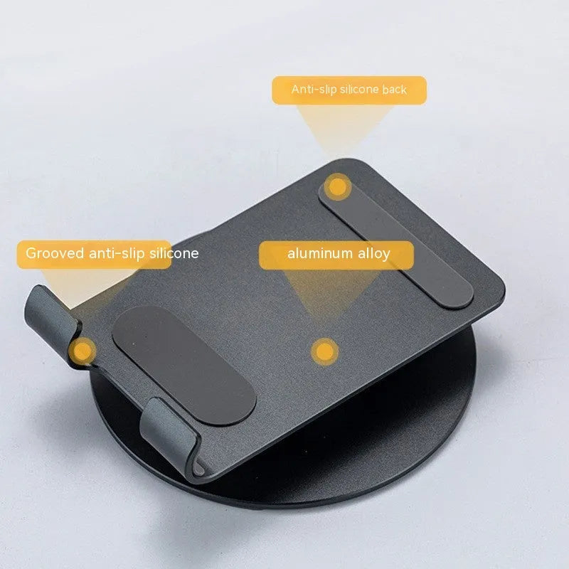 Aluminum alloy rotating mobile phone bracket in grey with silicone grip on desk showing phone in portrait mode