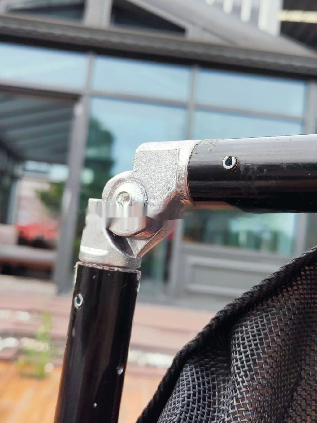 Black foldable aluminium alloy pet stretcher for large dogs, shown in emergency transport use.