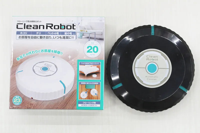 Black AC automatic sweeping robot vacuum cleaner on a wooden floor.