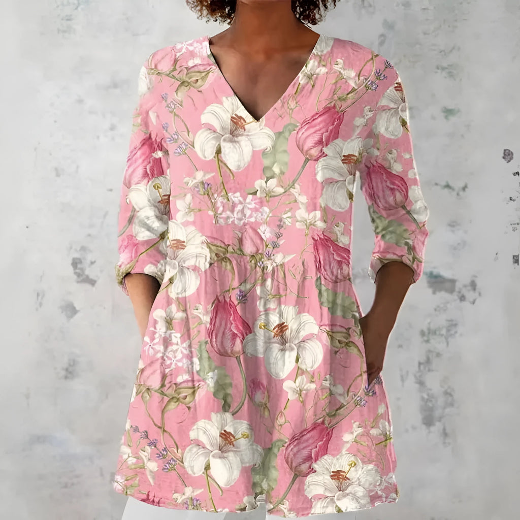 Woman wearing a retro slim fit, digitally printed long-sleeved top in a floral design.