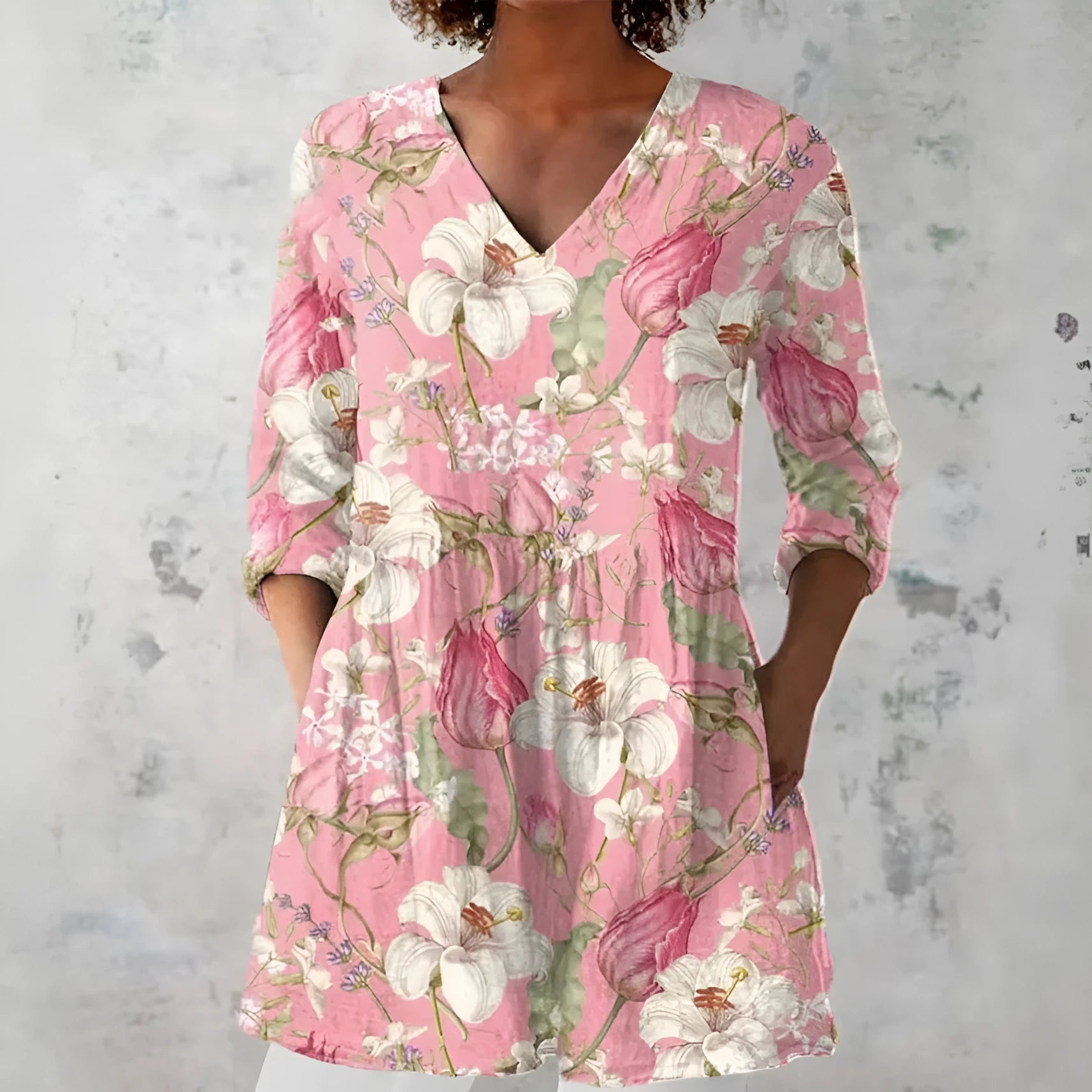 Woman wearing a retro slim fit, digitally printed long-sleeved top in a floral design.