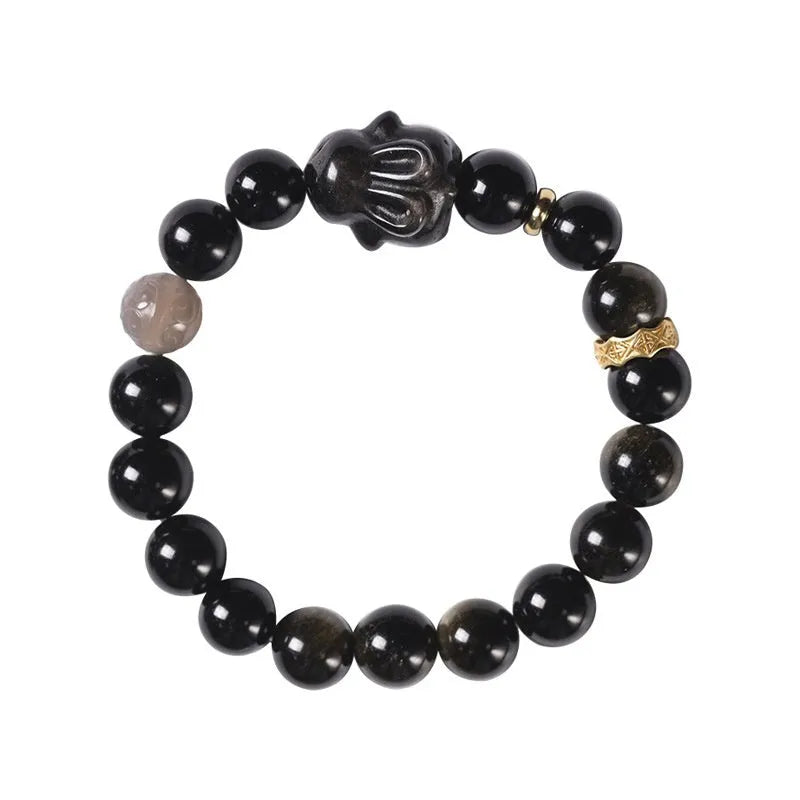 Handmade lying rabbit obsidian bracelet in brass with grey agate, showing national style design.