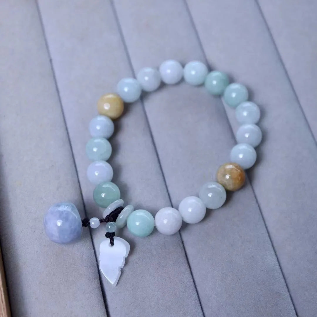 Emerald green jade bracelet with hanging symbolic charms including Maitreya Buddha design