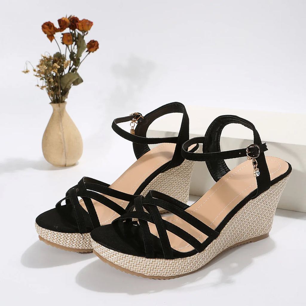 Women's wedge sandal with fish mouth toe design in black cloth upper.