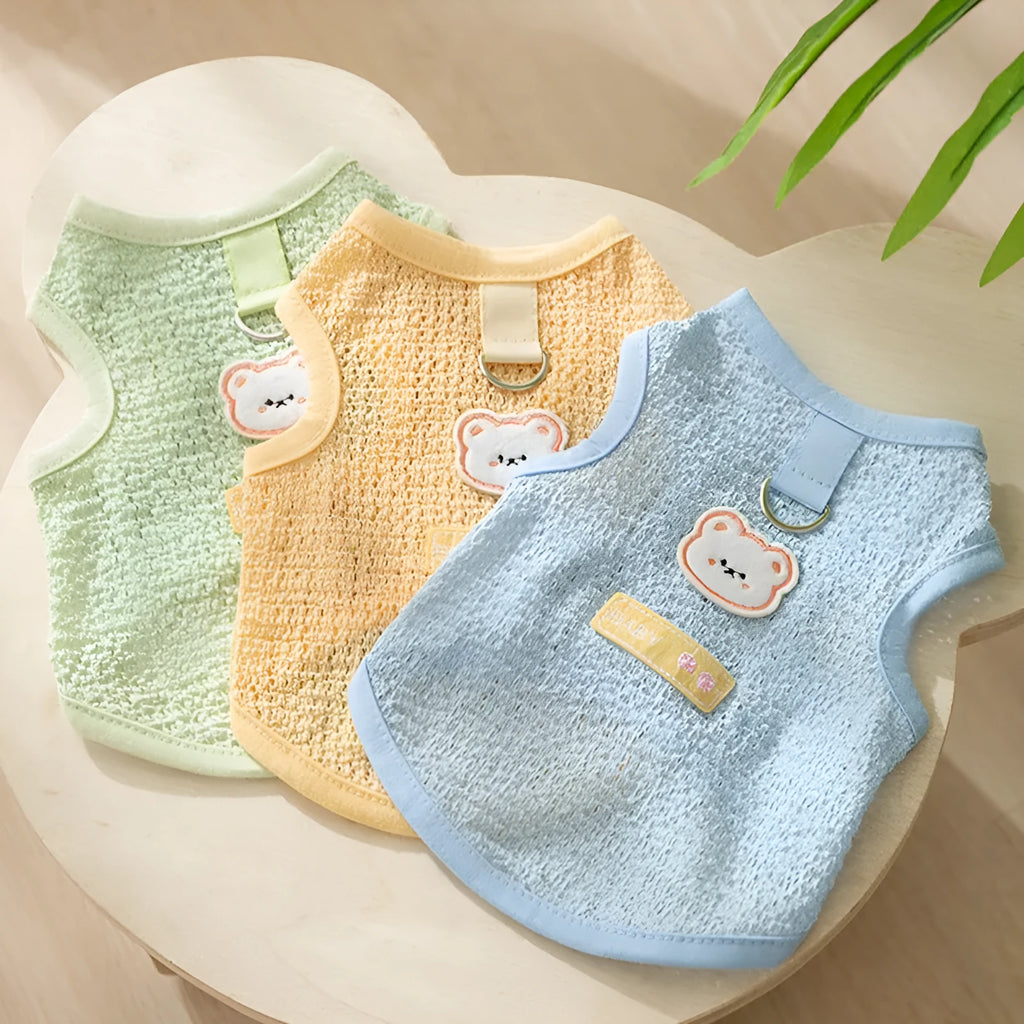 Green knitted cat clothing with a hollowed-out cartoon bear patch on the back.