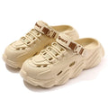 A pair of khaki men's outdoor slippers with a hollow-out pattern and a textured EVA sole.
