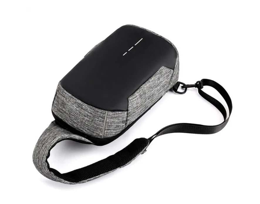 Small dark blue oxford cloth waterproof chest bag with a single strap and zipper.
