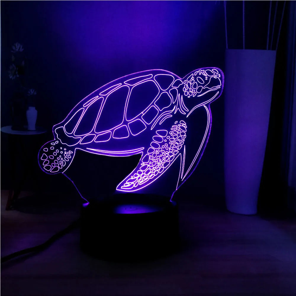 3D green turtle shaped LED night light glowing with multi-colours on a wooden table.