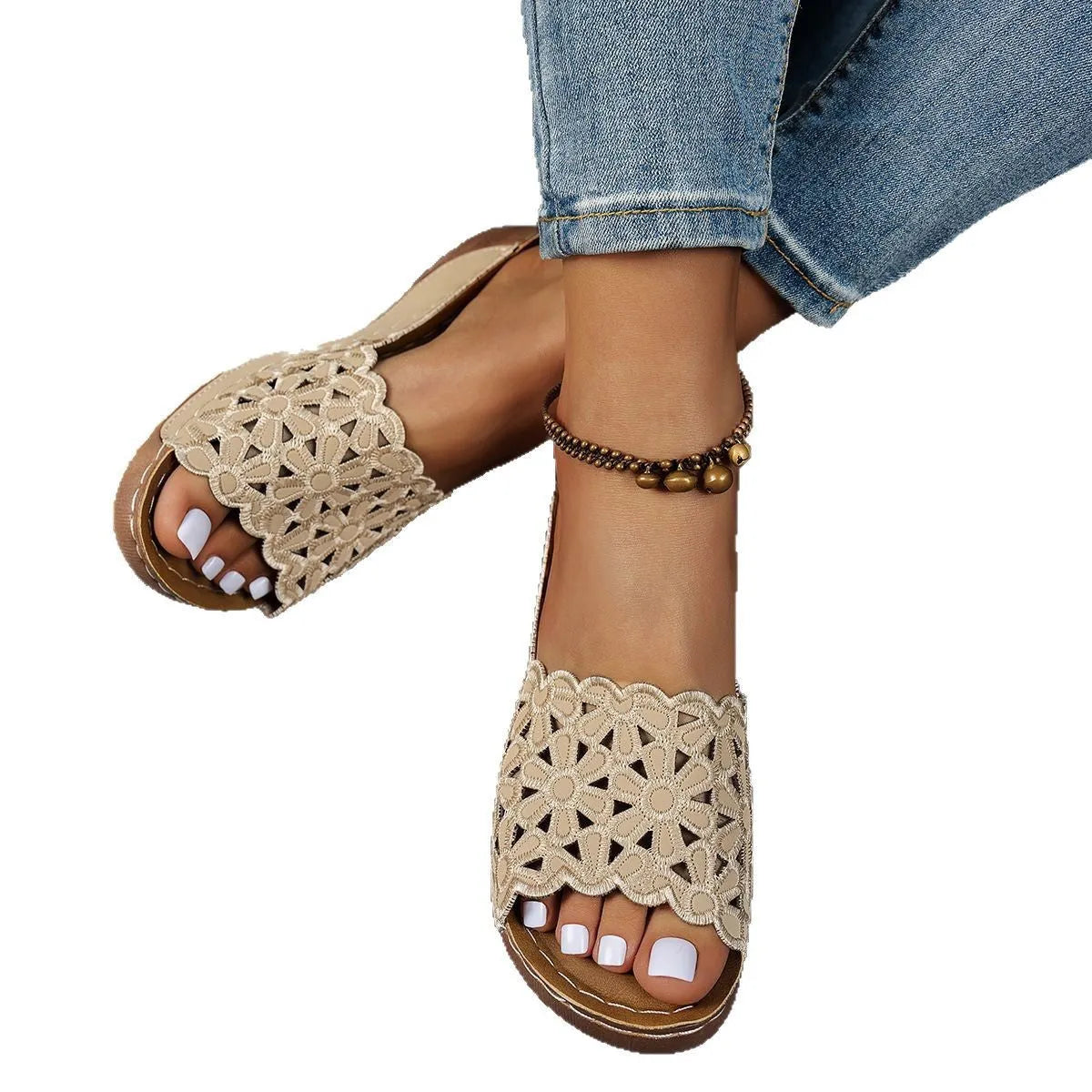 Women's black wedge beach slipper with floral cutouts and fish mouth toe shape on a rubber sole.