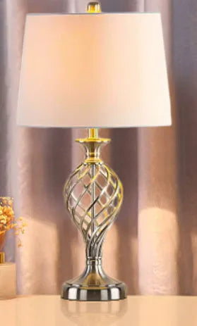 Silver alloy touch control bedside table lamp with USB cable on wooden surface