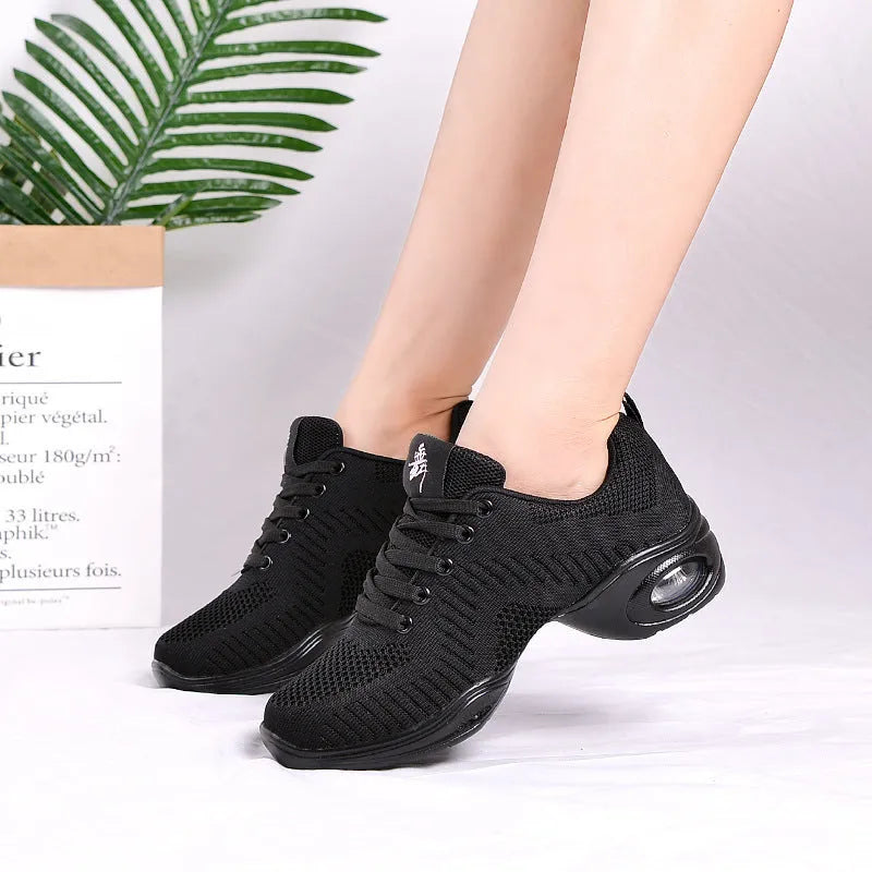Women's white breathable flyknit mesh dancing shoes with a soft PU sole on a light background.